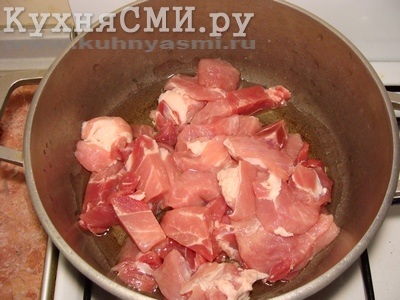 Порезанную кусочками свинину сложить в казан с подсолнечным маслом
