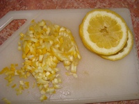 Половинку лимона измельчаем вместе с кожурой
